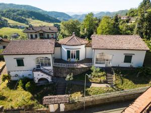 an aerial view of a house with mountains in the background at D'Aiano Guest House B&B in Castel dʼAiano