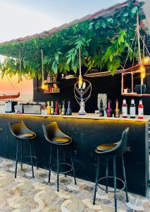 a bar with three stools in front of it at Horus Mini Resort in Cairo