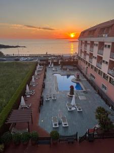 a view of a resort with a pool and the ocean at Hotel Nuevo Lanzada in A Lanzada