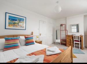 a bedroom with a large bed and a desk at The old ice cream parlour in Penzance