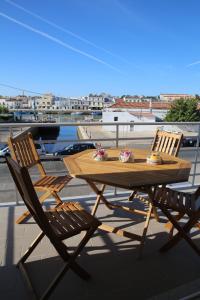 a wooden table and two chairs on a roof at Exclusive new apartment in Tavira in Tavira