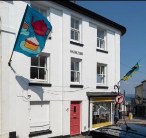 a building with a flag on the side of it at The old ice cream parlour in Penzance