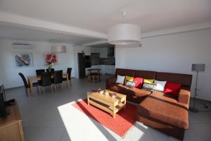 a living room with a couch and a table at Exclusive new apartment in Tavira in Tavira