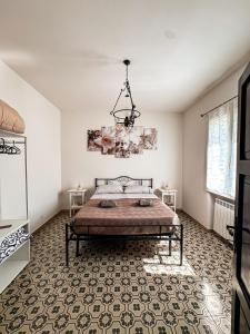 a bedroom with a bed and a chandelier at D'Aiano Guest House B&B in Castel dʼAiano