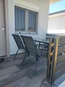 a room with a table and two chairs and a table and a window at Vigla summer house! in Paralia Sikias