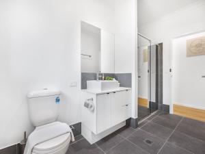ein weißes Badezimmer mit Toilette und Waschbecken in der Unterkunft Brand New Comfy Home 4Bedroom designer furniture in Springfield Lakes + 12 Fotos