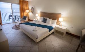 Postel nebo postele na pokoji v ubytování Hotel Arawak Beach Resort