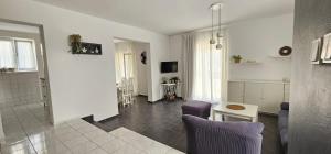 a living room with a couch and a table at LUKA APARTMENT in Posedarje
