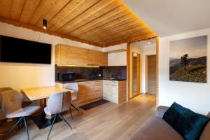 a kitchen and living room with a table and chairs at Kriendl Nr 1 in Valdaora