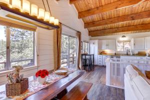 a kitchen and living room with a wooden ceiling at Snow Valley Hideaway Arrowbear Lake Retreat in Arrowbear Lake