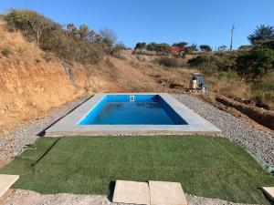 a swimming pool in the middle of a field of grass at Casa en parcela in El Convento