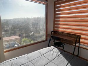 a bedroom with a desk and a bed and a window at Casa en parcela in El Convento +9 photos