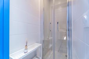 a white bathroom with a glass shower stall at Marseille soleil urbain in Marseille
