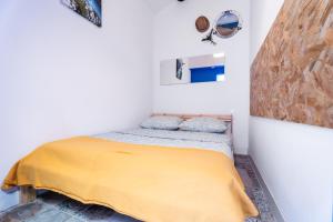 a bedroom with a bed with a yellow blanket at Marseille soleil urbain in Marseille
