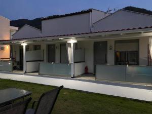 a house with a table and chairs in the yard at Harmony Studios & Apartments in Skala Potamias