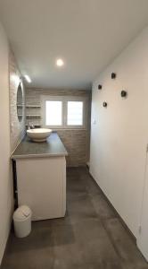 a bathroom with a sink and a counter top at Maison climatisée proche du lac in Sanguinet