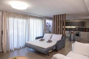 a living room with a bed and a couch at ILIOS Luxury Apartment in Iraklitsa