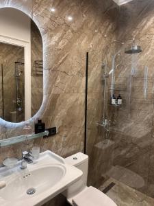a bathroom with a toilet and a sink and a shower at Easy Rest in Tbilisi City
