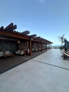 a resort with a deck with benches and the ocean at Grand Sapphire Resort & Casino with sea view in İskele