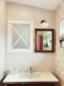 a bathroom with a sink and a mirror at Vila Omama in Palanga