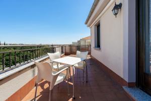 a balcony with a table and chairs and a view of the ocean at Hotel Eurowest in Salamanca