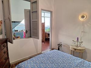 a bedroom with a bed and a window at Casa Por do Sol in Rio de Janeiro