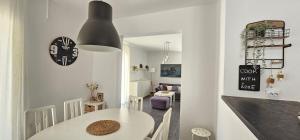 a dining room and living room with a white table at LUKA APARTMENT in Posedarje