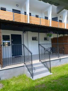 a staircase leading to a building with a balcony at Oaza Pieczyska in Koronowo +49 photos