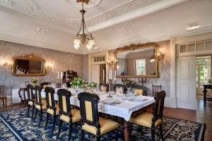a dining room with a long table and a mirror at Solar de Vilar Seco in Vilar Seco
