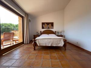 a bedroom with a bed and a large window at Quinta Mazagatos Segovia in La Lastrilla +61 photos