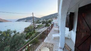 a balcony with benches and a view of the ocean at ZenSo Studios in Tolo