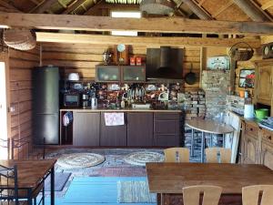 a kitchen with wooden walls and tables and a counter at Mirteli Talu in Tahkuranna