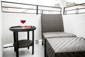 a table with a glass of wine and a chair at 3 Bedrooms in Newport Beach +13 photos