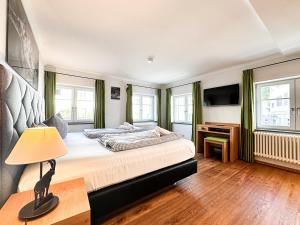 a bedroom with a large bed and a desk at Staufen in Oberstaufen