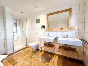 a bathroom with two sinks and a shower and a toilet at Staufen in Oberstaufen +17 photos