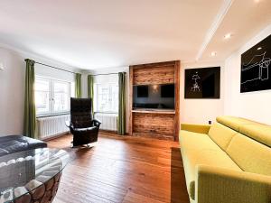 a living room with a couch and a chair at Staufen in Oberstaufen