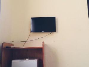a flat screen tv hanging on a wall at Single Room - Ground Floor in Accra +13 photos