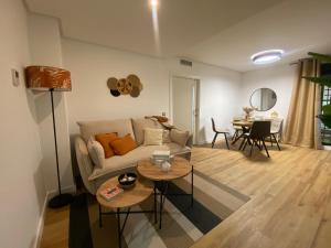 a living room with a couch and a table at El Paraíso de Fuentebravía - Primera Línea de Playa in El Puerto de Santa María