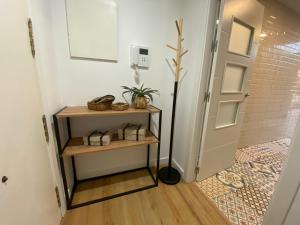 a hallway with a door and a shelf with a plant at El Paraíso de Fuentebravía - Primera Línea de Playa in El Puerto de Santa María +43 photos