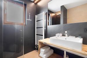 a bathroom with a sink and a shower at Villa Kriendl Nr 4 Dreifinger in Valdaora +21 photos