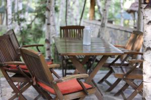 a wooden table and chairs on a patio at Stani i Hoxhes Hotel in Kukës +47 photos
