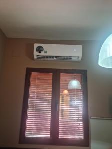 a room with a window and a air conditioner on the ceiling at El Cervunal in Arenas de San Pedro +12 photos