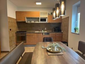 a kitchen and dining room with a wooden table at Relax & Lounge Apartments in Premantura