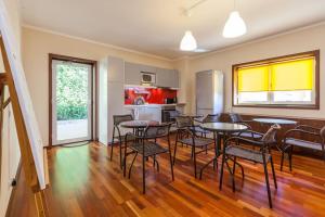 a dining room with tables and chairs and a kitchen at Sweet Home Braga - 4 rooms apartment in Braga