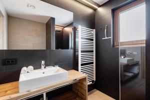 a bathroom with a sink and a glass shower at Villa Kriendl Nr 3 Piz da Peres in Valdaora +22 photos