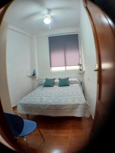 En eller flere senge i et værelse på Comfort Apartamento Compartido