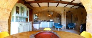 a kitchen and dining room with a table and chairs at La Cava - Palazzo Pallotti in Bagnoregio