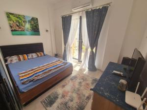 a bedroom with a bed and a window with curtains at Seb apartment mamaia nord in Năvodari