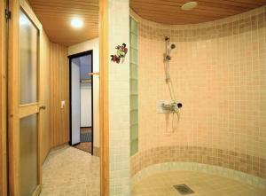 a bathroom with a shower with a tiled wall at Forenom Apartments Rauhankatu 16 in Lahti +35 photos