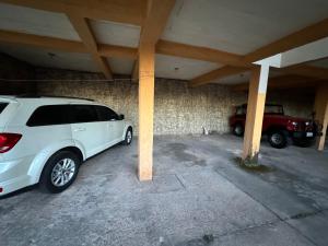 a white car parked in a parking lot at Casa de Temporada em Diamantina in Diamantina